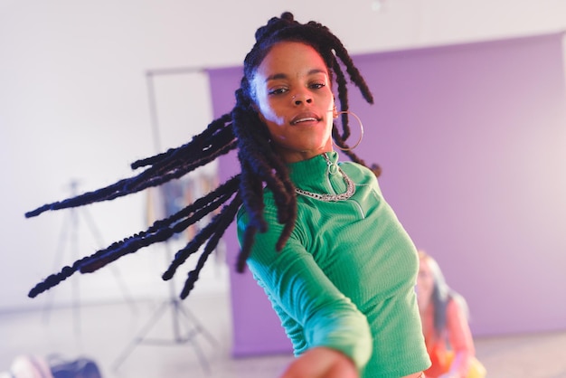 Image of happy afican american female hip hop dancer in studio. Dance, rhythm, movement and training concept.