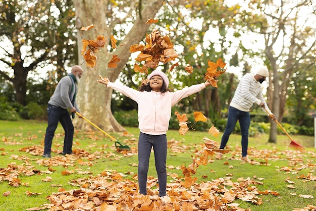 Photo image of happy african american multi generation family having fun in autumn garden