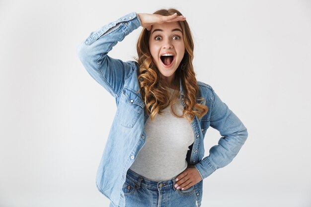 Image of a happy beautiful young pretty woman posing isolated over white wall  looking camera.