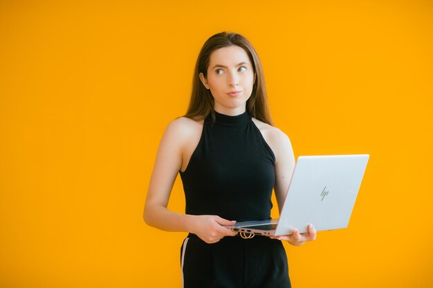 Image of a happy optimistic emotional young woman using laptop computer