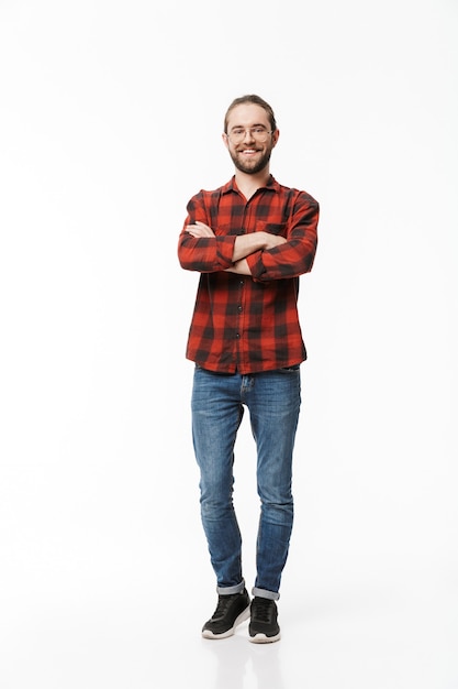 Photo image of a happy young handsome bearded man posing isolated over white wall.