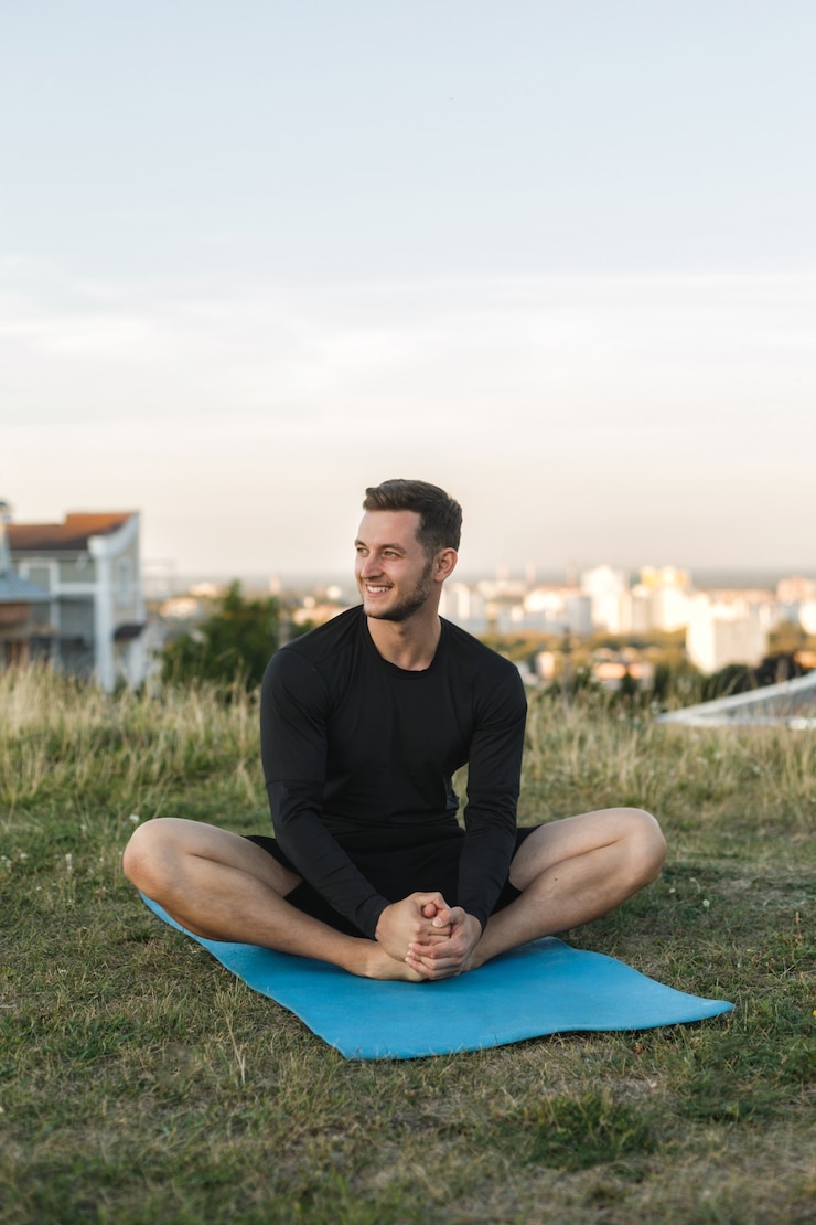 Photo image of healthy man stretching his body at sports ground outdoors