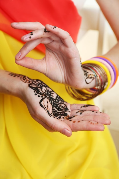 Image of henna on female hands closeup