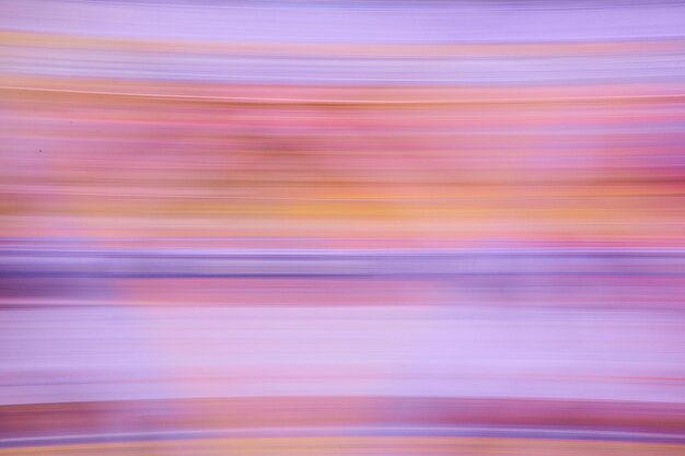 Image of horizontal blur of colorful lines of pink and purple with hint of orange