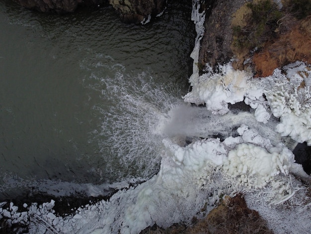 Photo an image of the ice flows from the dam into the water