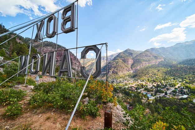 Image of Iconic Box Canon sign of Ouray, Colorado from behind and overlooking town surrounded by mountains