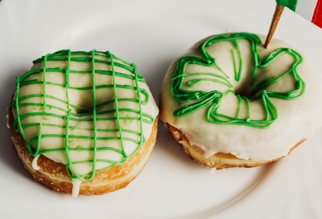 Image of an Irish breakfast to celebrate Saint Patrick consisting of two homemade donuts and a beer