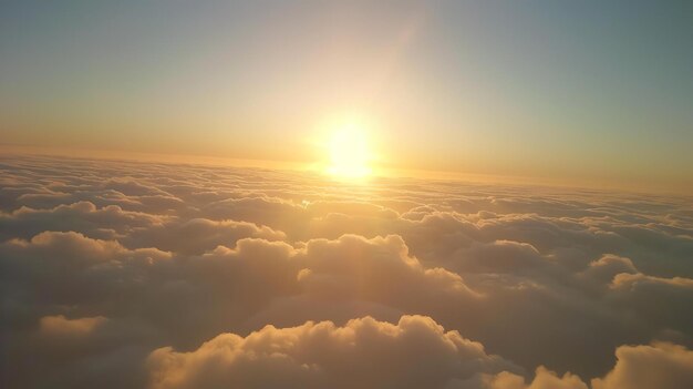 The image is a beautiful sunset from above the clouds The warm colors of the sunset and the soft clouds create a peaceful and serene scene