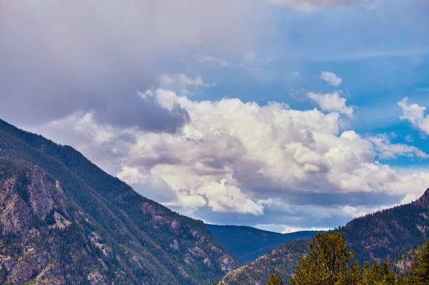 Image of Large clouds over big mountains in desert