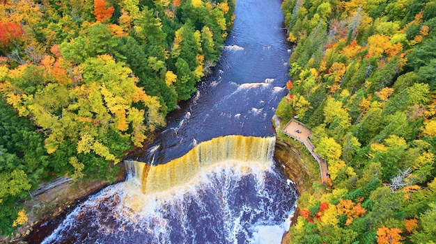 Photo image of large waterfall at tahquamenon falls aerial shot during the fall