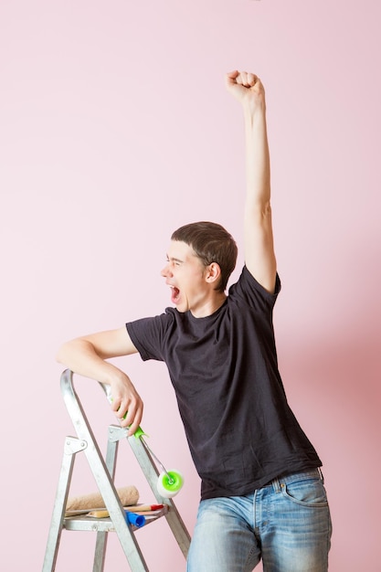 Image of man in black Tshirt with roller in hands