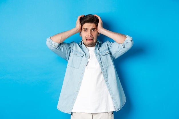 Image of man in panic holding hands on head