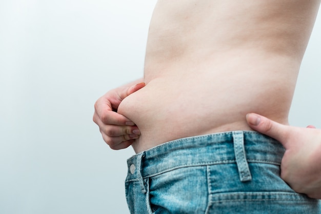 Image of man's obese belly, isolated on white background