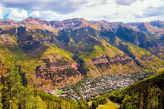 山の開いた谷に押し込まれた秋の近くのテルライドの山の町の画像