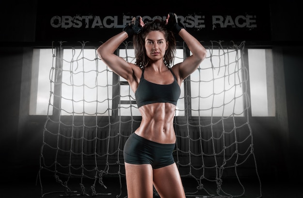 Image of a muscular woman working out in the gym.