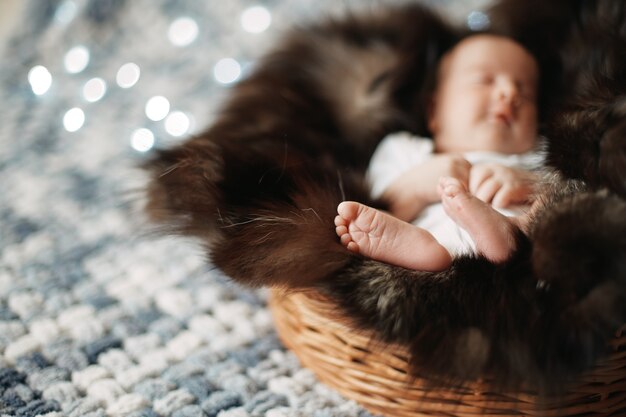 Image of a newborn baby sleeping in a baby basket