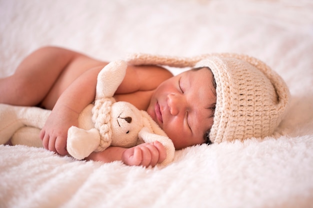 image of a newborn brazilian baby curled sleeping in a blanket