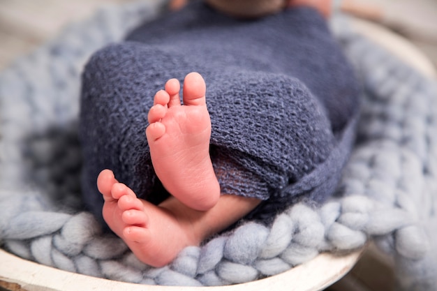 image of a newborn brazilian baby curled sleeping in a blanket