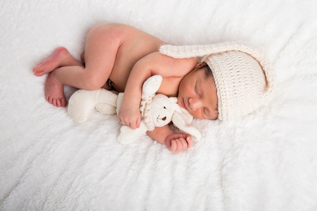 image of a newborn brazilian baby curled sleeping in a blanket