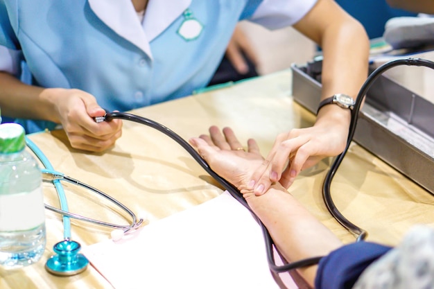 Image of the nurse's hand is measuring the pulse And patient pressure