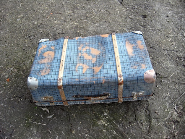 Image of old suitcase on the ground