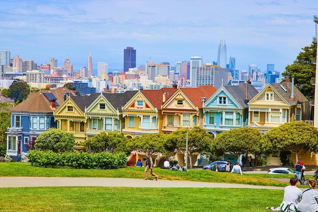 Image of People on Alamo Square lawn with The Painted Ladies and San Francisco skyline