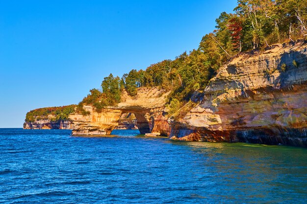 Image of Pictured Rocks on Lake Michigan with cliff overhang and hollowed out tunnel