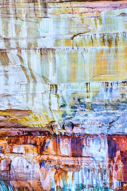 Image of Pictured Rocks with streaks like paint on its white, yellow, red and orange surface