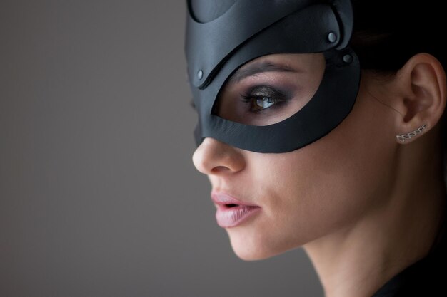 Photo image of playful catwoman posing looking at camera