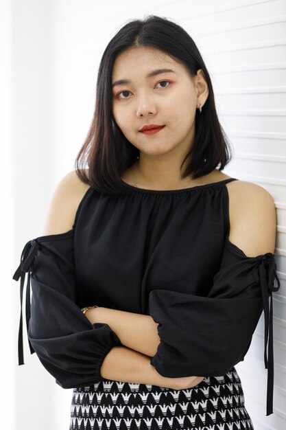 Image of portrait. Asian smiling plump woman wearing black dress. Lady asia standing against white background. Concept working to confident.