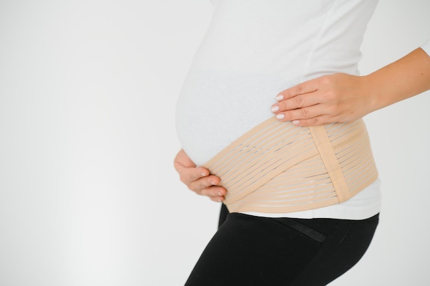 Image of pregnant woman touching her belly with hands