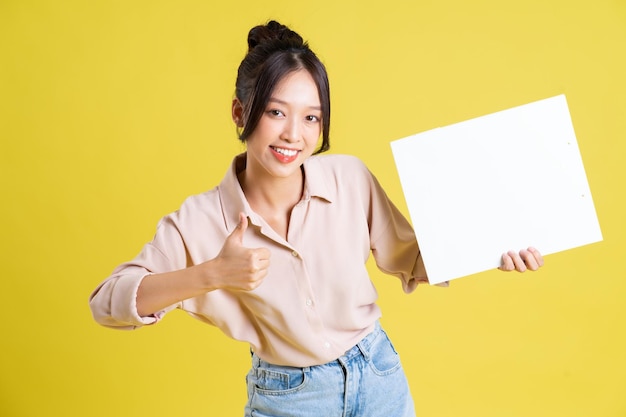 Image of a pretty asian girl holding a white billboard