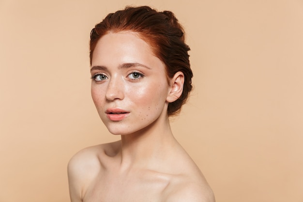 Image of a pretty young redhead woman posing isolated.