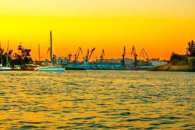 Image river and yacht harbor at sunset