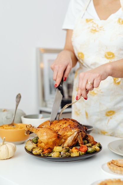 Image of roasted turkey being cut by a human