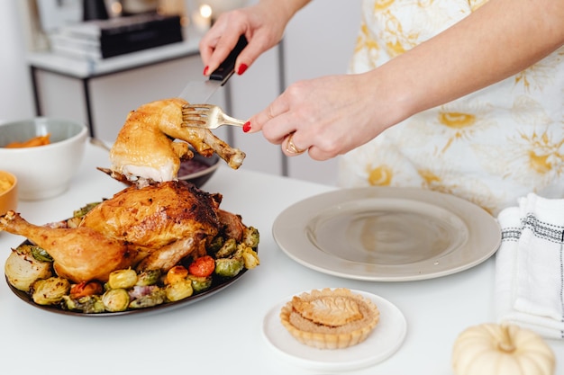 Image of roasted turkey being cut by a human