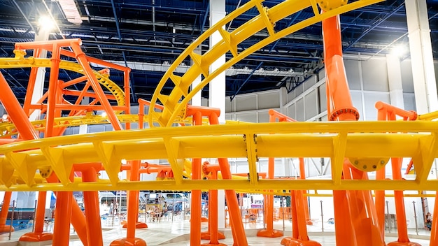 Image of roller coaster with extreme fast loops in big shopping mall