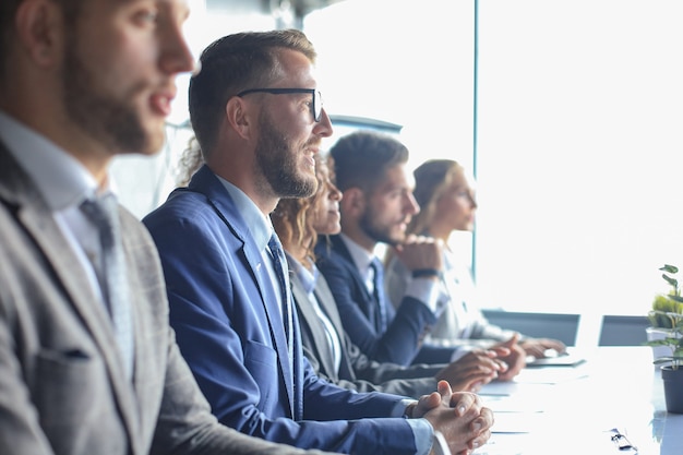 Image of row of business people working at seminar.