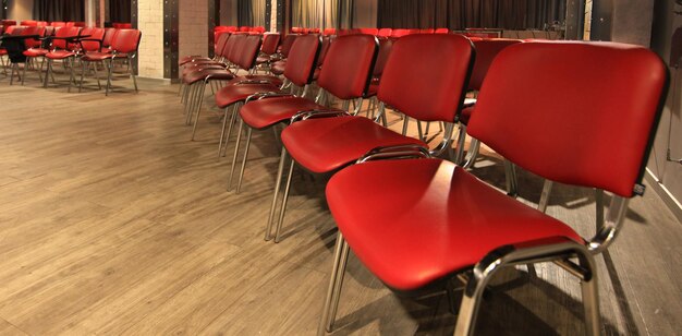 Image of rows of red chairs in an empty conference room