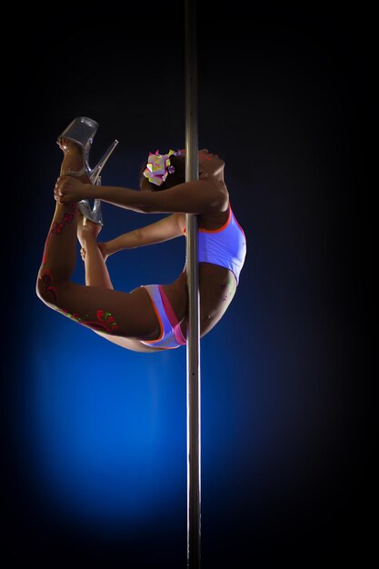 Image of seductive pole dancer posing in jump