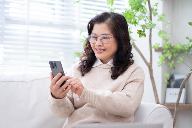 Image of senior Asian businesswoman working at home