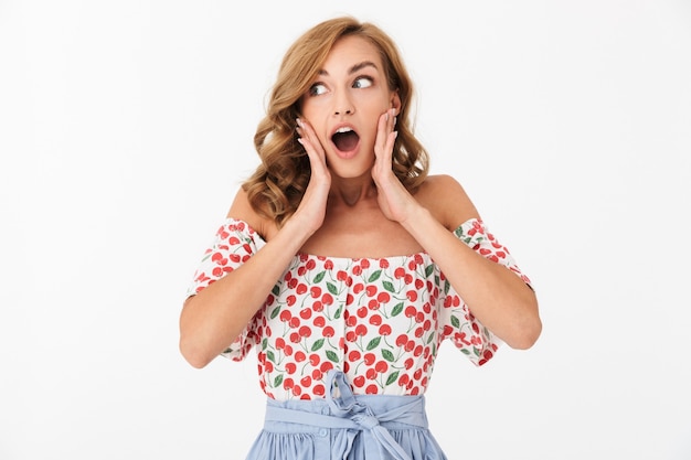 Image of a shocked young emotional woman posing isolated over white wall.