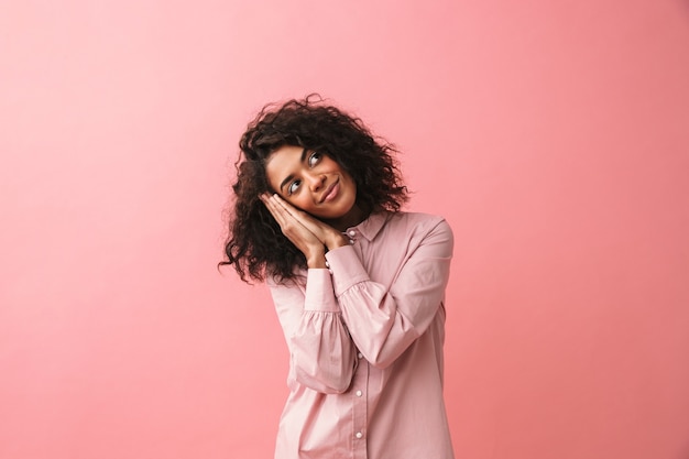 Image of sleepy beautiful young african woman posing isolated dressed in pajama.