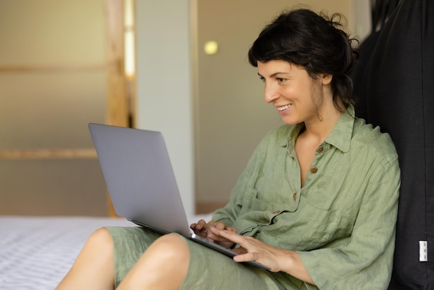 Image of smiling woman looking at laptop