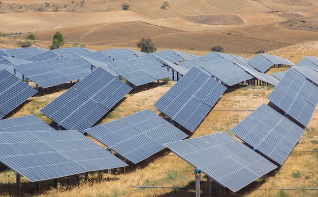 Image of solar panels on a summer day forming waves that adapt to the terrain