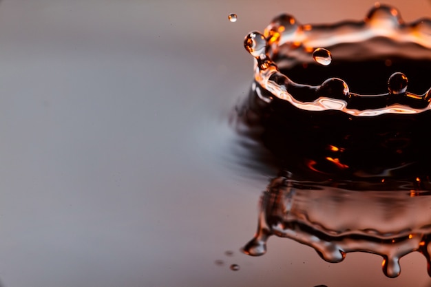 Image of Sunset waterdrop with black and white with the gold and red hue of a sunset