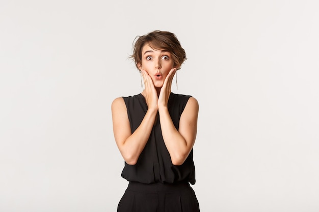 Image of surprised fashionable woman looking with amazement