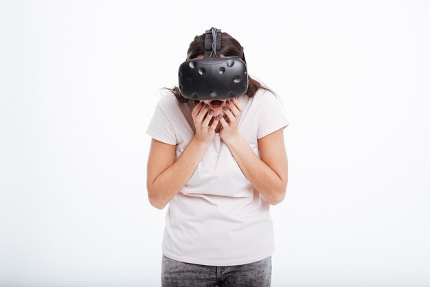 Image of surprised happy woman wearing virtual reality device .