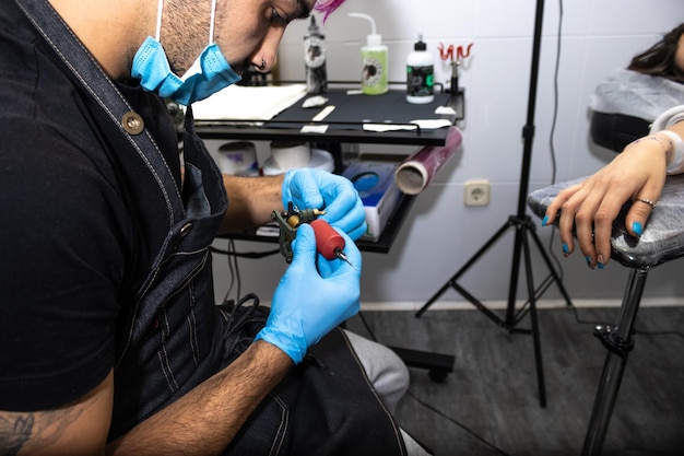 Image of a tattoo artist preparing the tattoo razor in his studio