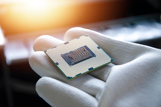 An image of a technician holding a CPU in his hand